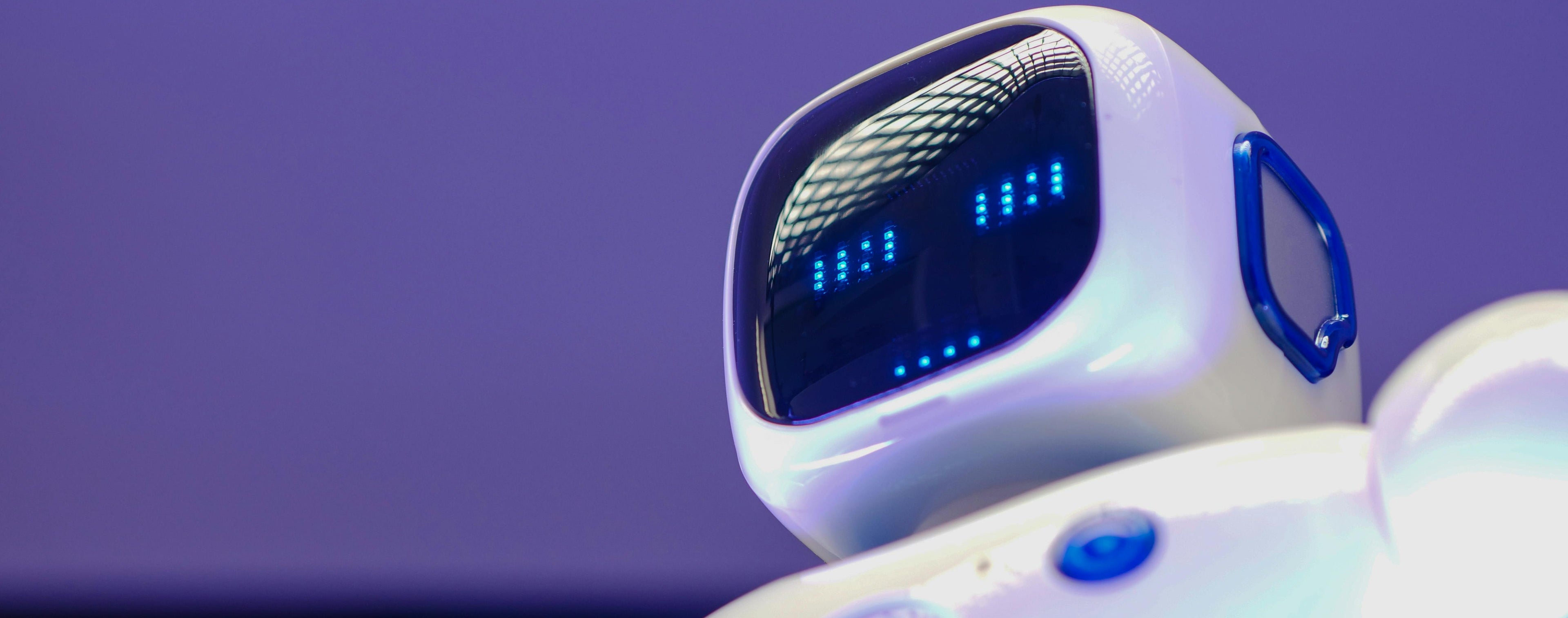 White robot with blue accents on a dark background